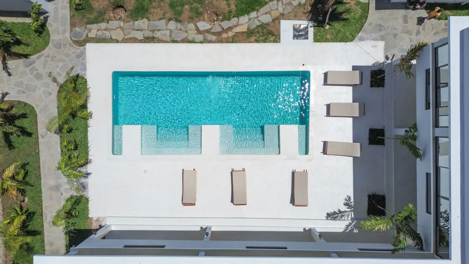 Aerial view of the TAWI pool and roof terrace among the gardens of Watamu