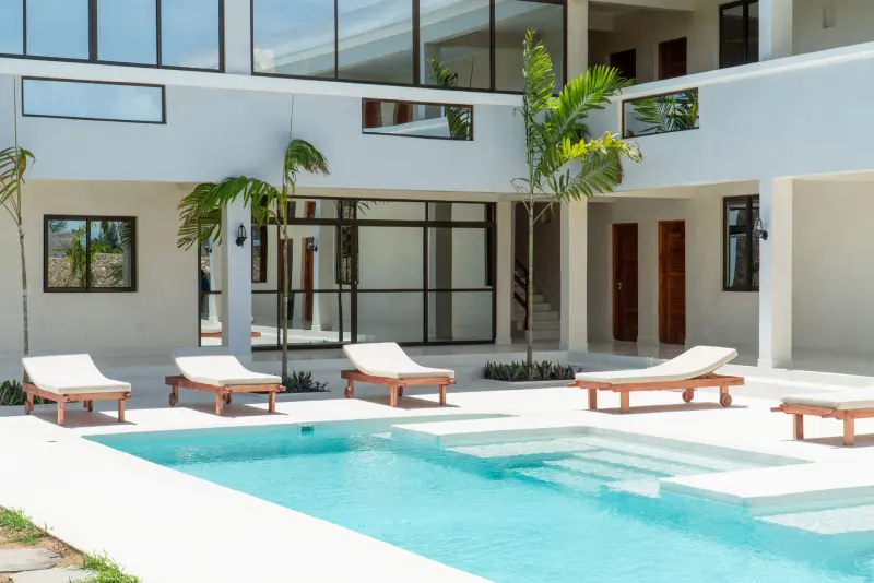 The courtyard pool and loungers in front of the rooms